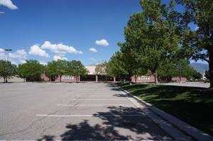 Trees line a strip of lawn in the center of the parking lot. - , Utah