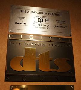 An old 'This Theatre Features DTS' plaque remains on the wall long after the theater upgraded to digital projection. - , Utah