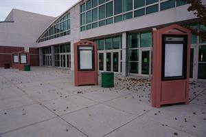 Autumn leaves blow around empty poster cases at the entrance of the former entertainment complex. - , Utah