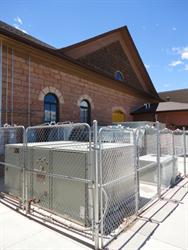 A chain link fence surround equipment at the rear of the building. - , Utah