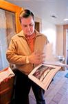 Gene Peckham looks through a grant proposal in the foyer of the dance hall. - , Utah