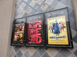 A set of three movie posters on an exterior wall. - , Utah