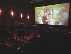 Commercials play on the screen in Theater 18 while moviegoers await the feature presentation. - , Utah