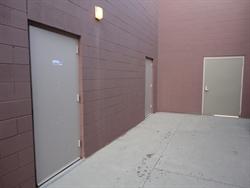On the left are theater exit doors. The door ahead leads to the wall off section of the alley. - , Utah