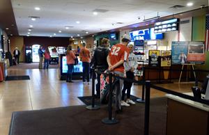Several moviegoers stand in line at the box office and concession stand. - , Utah