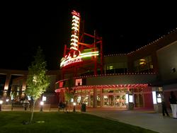 Theater entrace at night.  Above the wide, circular entrance is are two electronic attraction boards - , Utah