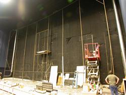 Two men work at the front of Theater 11, where the screen will be installed. - , Utah