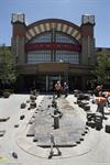 Workers install brick down the center of the walkway to the theater. - , Utah