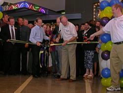 A Megaplex Theatres employees provides a regular pair of scissors to use for the ribbon cutting. - , Utah