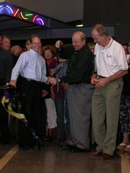 Mayor Matthew Godfrey and Larry H. Miller smile as the cut ribbon falls to the floor. - , Utah