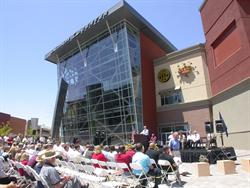 An audience seated on folding chairs listens to a speaker in front of the Salomon Center. - , Utah