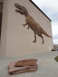 A sculpture of a tyrannosaurus rex on the northeast exterior wall of the Mammoth Screen Theatre.
