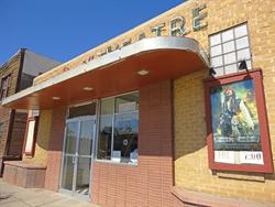The entrance has poster cases on either side of glass doors and a ticket window. - , Utah