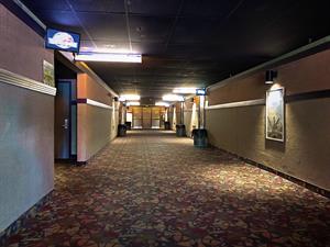 A wide hallway has entrance doors for three auditoriums on each side. - , Utah