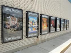 Eight poster cases along the front wall of the theater. - , Utah