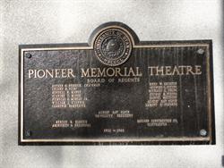 A plaque  on the left side of the entrance lists the board of regents, architect, and contractor for the Pioneer Memorial Theatre. - , Utah