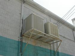 Two air conditioning units side on a platform on the back wall of the main building. - , Utah