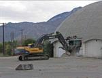 A Volvo demolition excavator begins tearing down a wall on the north dome. - , Utah