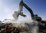 A demolition excavator stands on a pile of rubble and dust. - , Utah