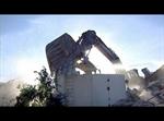 The claws of demolition excavator take out a section of wall. - , Utah