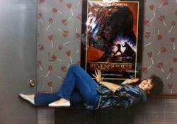 An employee lies on a table right below a poster mounted on a wallpapered wall. - , Utah