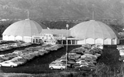 Rows of a cars fill the parking lot, with the twin dome theater in the background. - , Utah