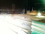 Workers install floorboard across the new joists. - , Utah