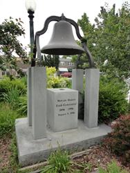 A bell over a monument that reads, "Midvale Honors Utah Centennial, 1896 - 1996." - , Utah