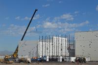 A crane lifts a girder for an auditorium ceiling. - , Utah