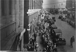 Looking down from a second story at the line of children leading away from the Capitol Theatre. - , Utah