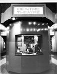 A man in a suit and bow tie sits in the ticket booth of the Centre Theatre. - , Utah