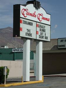 A back-lite sign supported by two posts, with a decorative keystone at the top, the Carmike Cinemas logo, and an attraction board for four theaters. - , Utah