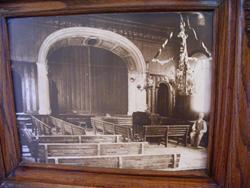 A framed photograph of the hall, with the proscenium arch at the far end.
