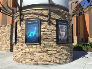 Posters line the circular base for the theater's sign. - , Utah