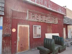 A door and poster case in the middle of the west exterior wall. - , Utah