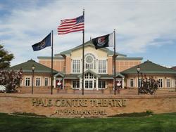 A curving brick wall bears the name of Hale Centre Theatre at Harmon Hall.