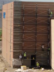 Men work on the exterior wall of one of the two largest auditoriums. - , Utah