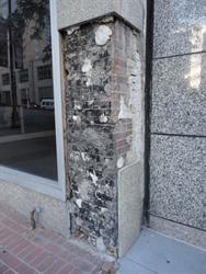 On the southwest corner of the building, sections of the most recent facade have fallen, revealing the brickwork underneath. - , Utah