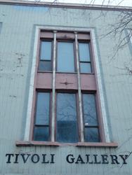 A notch in the window sill and plus-shaped markings above the center windows could indicate the building once had a vertical blade sign. - , Utah