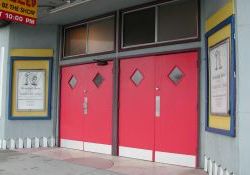 The entrance of the theater consists of two sets of double doors, with poster cases on either side and skylights above. - , Utah