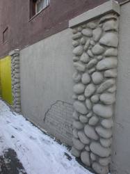 Next to one of the stone pillars is a patch of wall where the brick beneath is showing. - , Utah