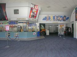 The lobby of the theater, with the concession stand on the left and the hallway to the theater auditoriums on the right.