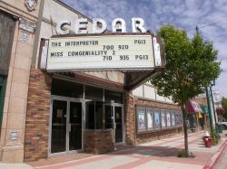 The Cedar Twin theater has a triangular marquee with a five-line attraction board and the name of the theater, 'Cedar'. - , Utah