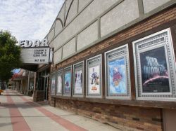Poster cases line the front of the twin screen theater.  A tree blocks the view of one side of the theater's marquee. - , Utah