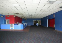 The lobby of the City Square 4 Theater.  The concession stand is on the left.  In the center at the far end is the hall to the theaters.  On the right are rest rooms.