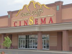 Above the entrance of the theater is the Coral Cliffs Cinema 8 logo, which has mountains in the background and the number 8 in the middle of the word Cinema. - , Utah