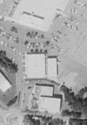A black and white aerial photo shows the west end of Cottonwood Mall in the top, with another building between it and the theater at the bottom of the photo. - , Utah