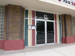 The entrance of the Towne Theatre has a two glass doors between brick columns. - , Utah