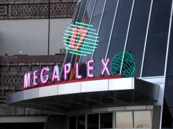 Above the south entrance of the Megaplex 17 at Jordan Commons is name 'MEGAPLEX' and the number 17 surrounded by a globe of neon lines. - , Utah