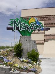 Flowers are planted around the circular base for the Mayan's neon sign. - , Utah